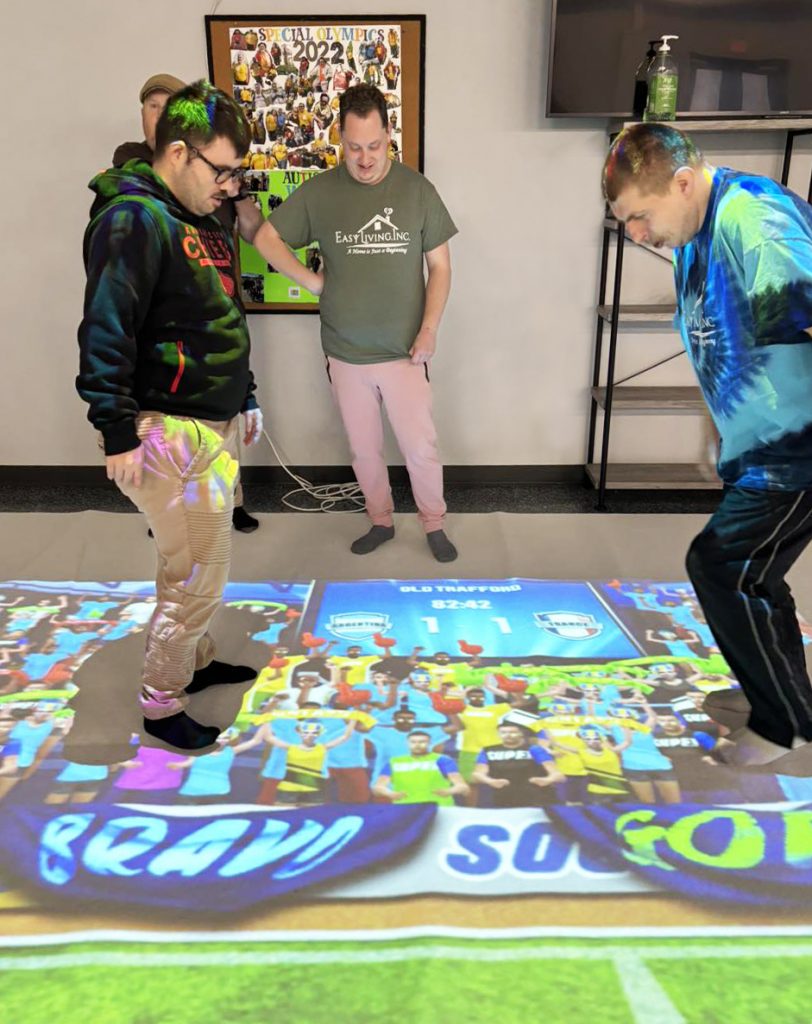 people playing game with interactive projector