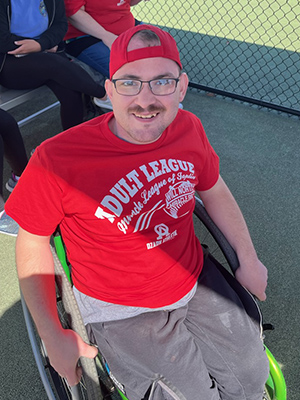 Miracle League player in wheelchair in dugout