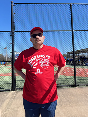 Miracle League player standing by the fence of the infield