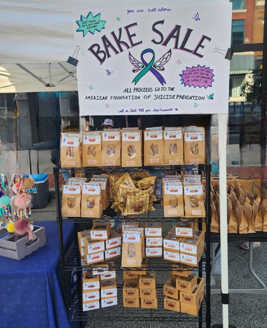 Bake Sale sign at the top of a rack of all the goodies to buy