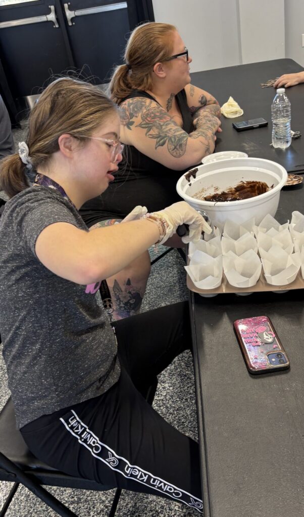 member filling large muffin baking